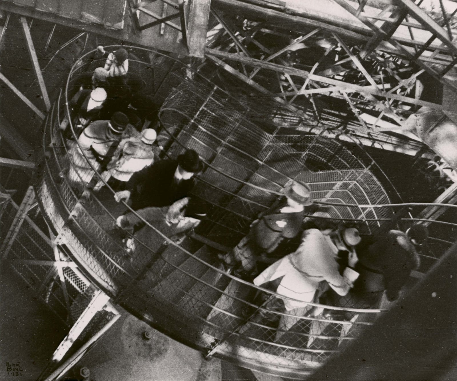 Ilse Bing photograph of visitors climbing up the stairs to the Eiffel Tower Paris