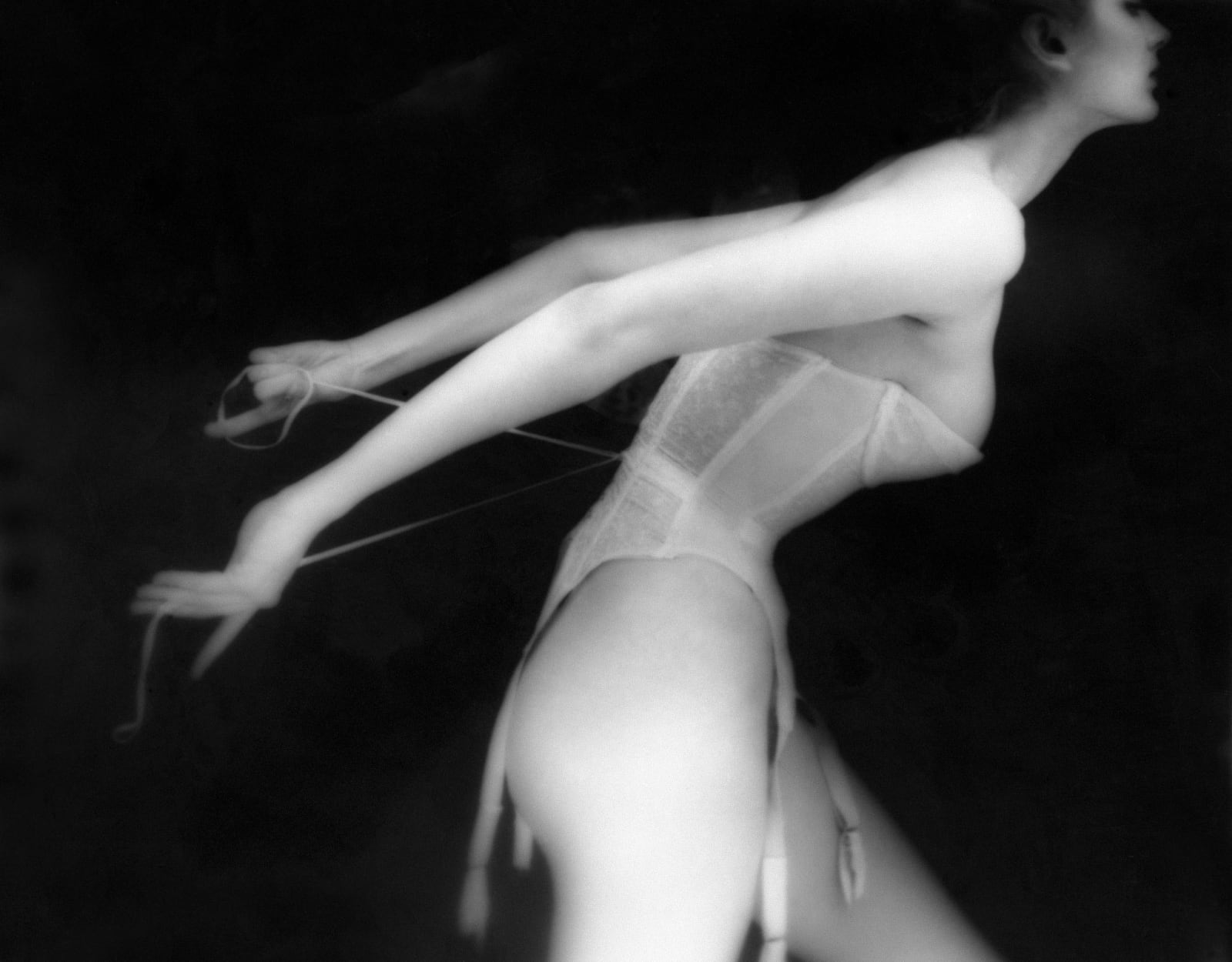 Woman in corset lingerie by Lillian Bassman