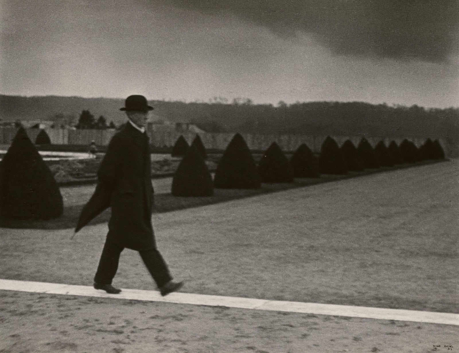 Ilse Bing photograph of bourgeois man walking along path