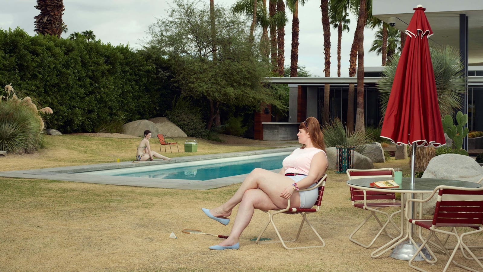 Two women sitting by pool in Palm Springs, California by Erwin Olaf