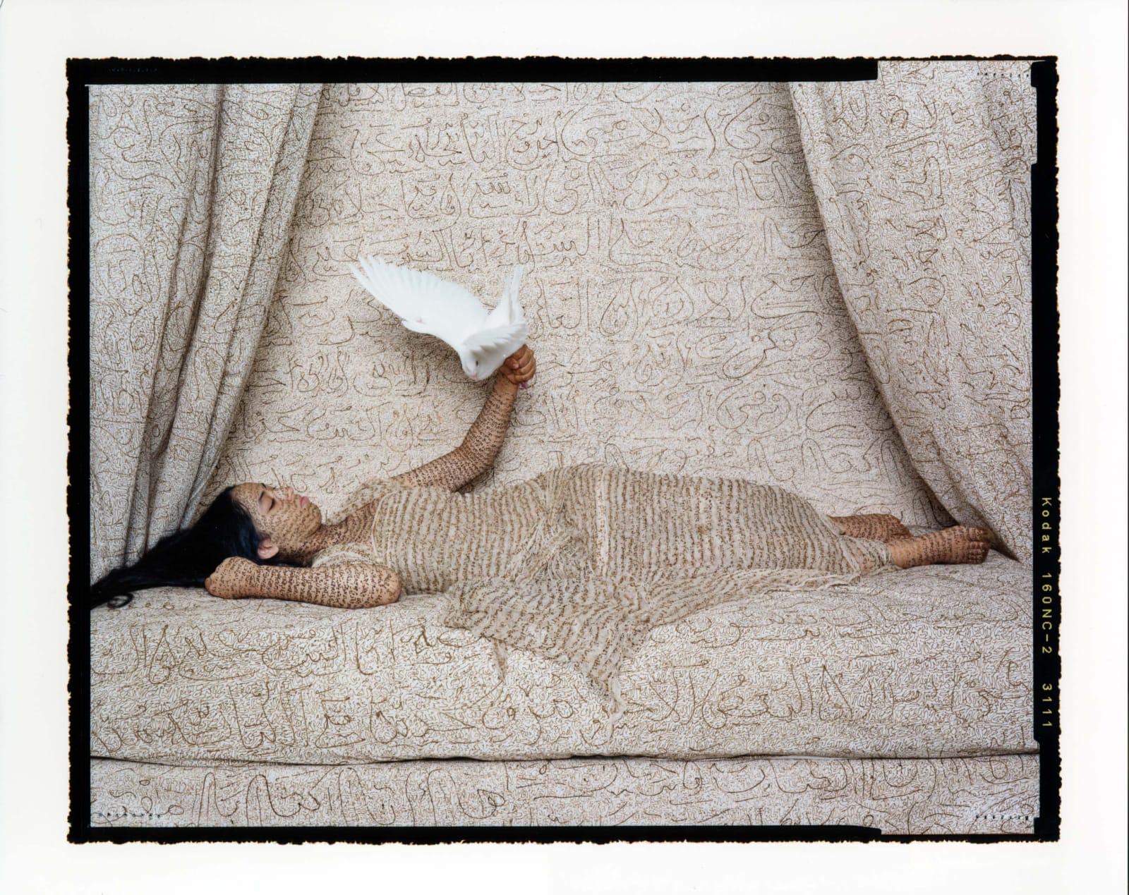 Reclining woman with white dove flying from hand, from Les Femmes du Maroc series by Lalla Essaydi