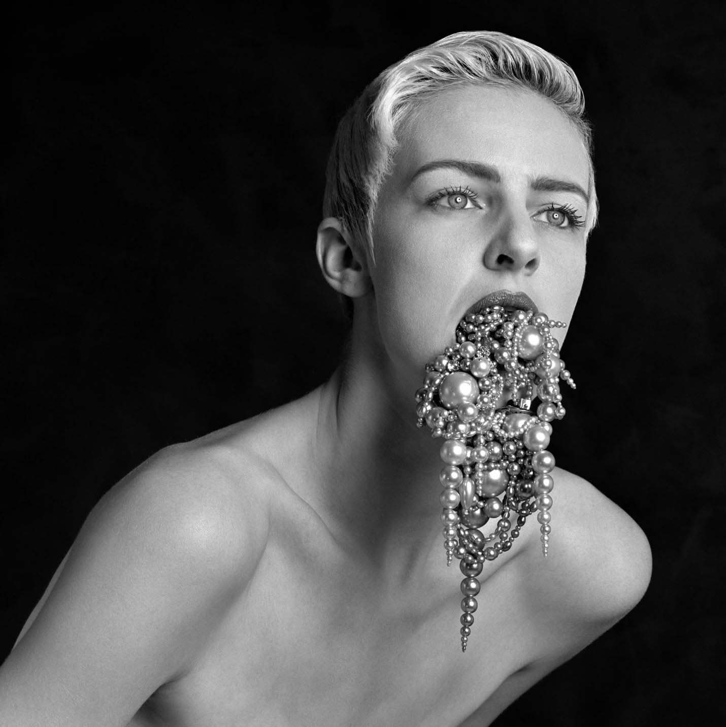 Erwin Olaf portrait of woman in black and white with pearls pouring out of her mouth