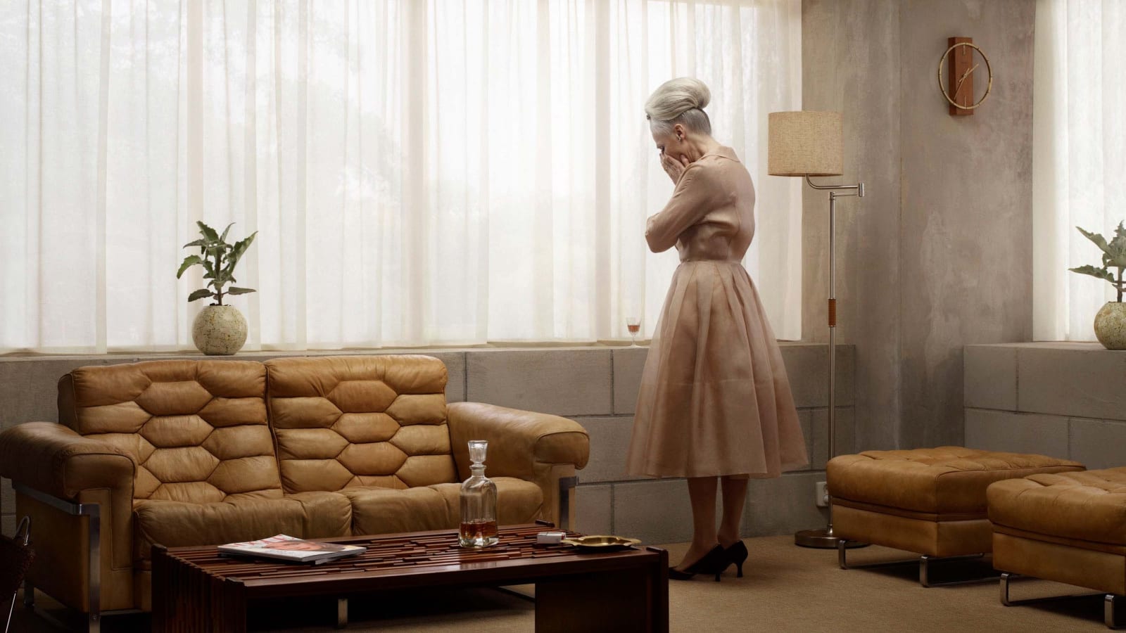 Grace standing in midcentury living room, head in hands, from the Grief series by Erwin Olaf