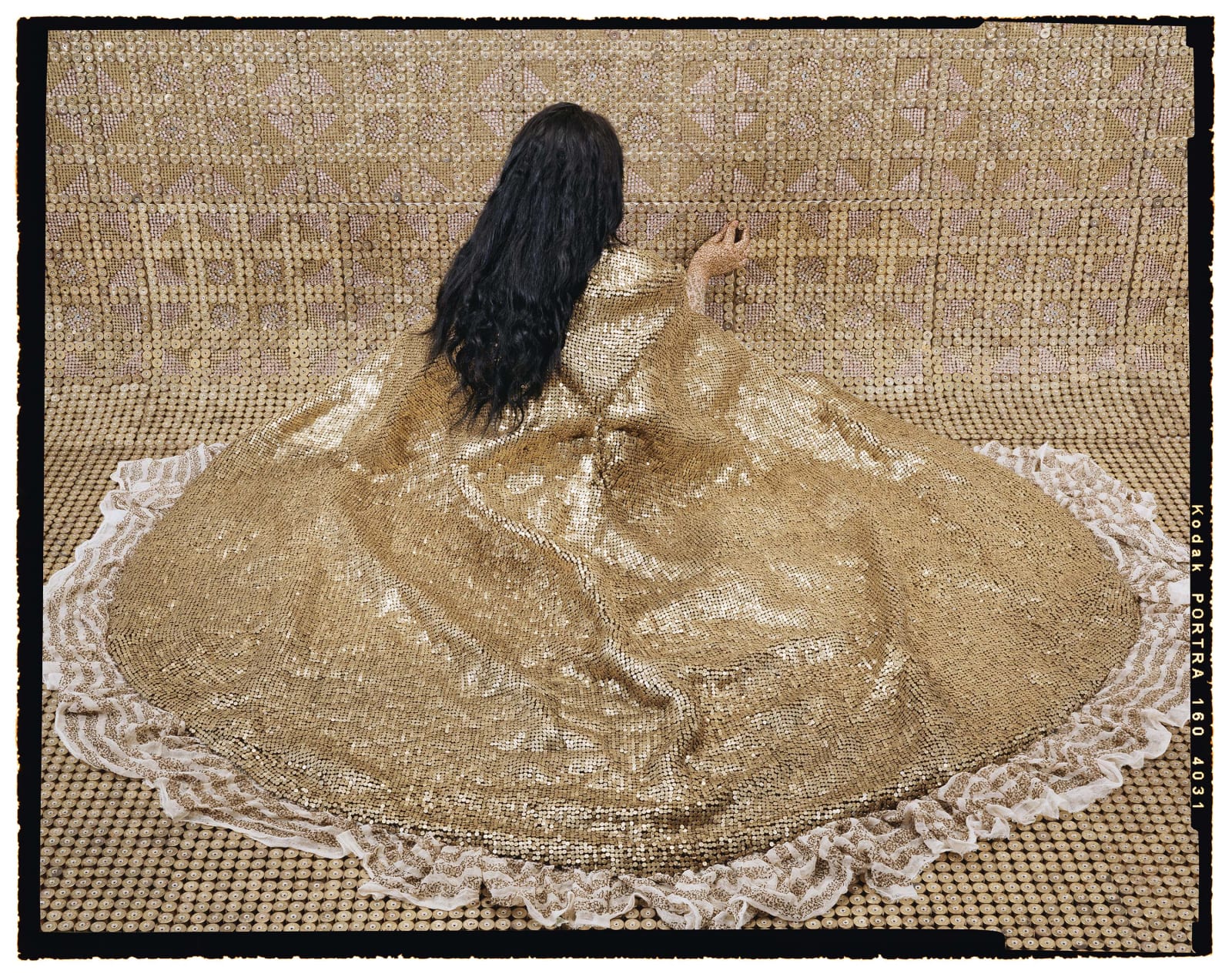 Lalla Essaydi Bullets Revisited #20, 2013, Woman wearing golden cloak facing golden wall