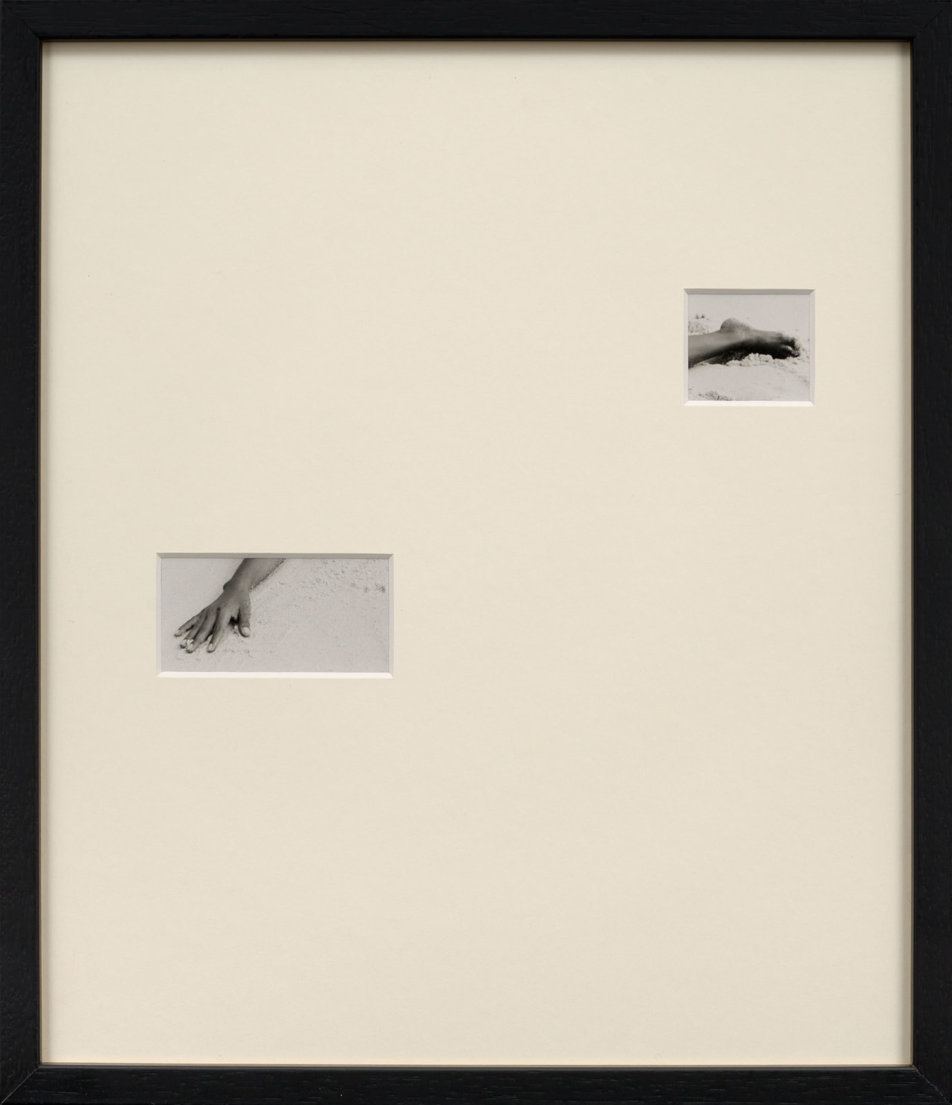 Framed photograph with overmat and cutouts showing a photograph of a hand and foot by Sissi Farassat