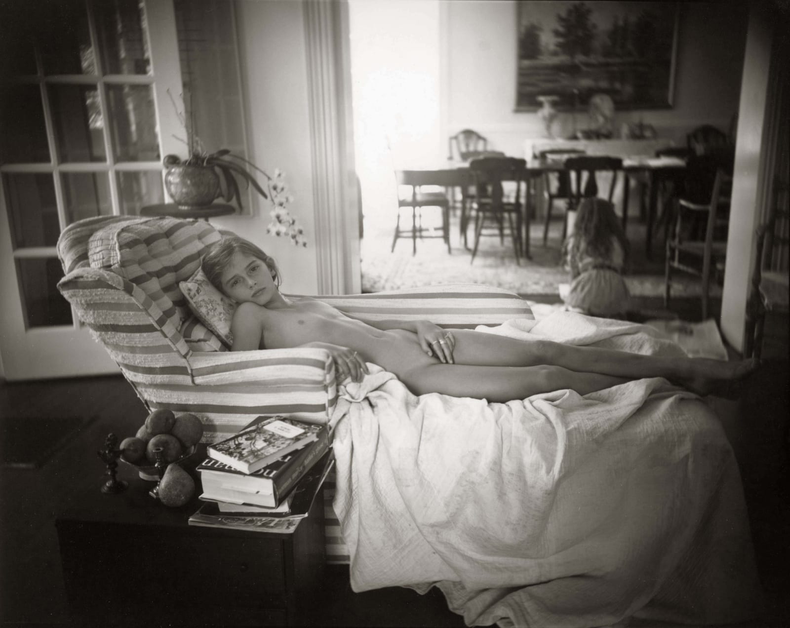 Jessie reclining on couch in pose evoking Titian's Venus of Urbino, from the Immediate Family series, by Sally Mann