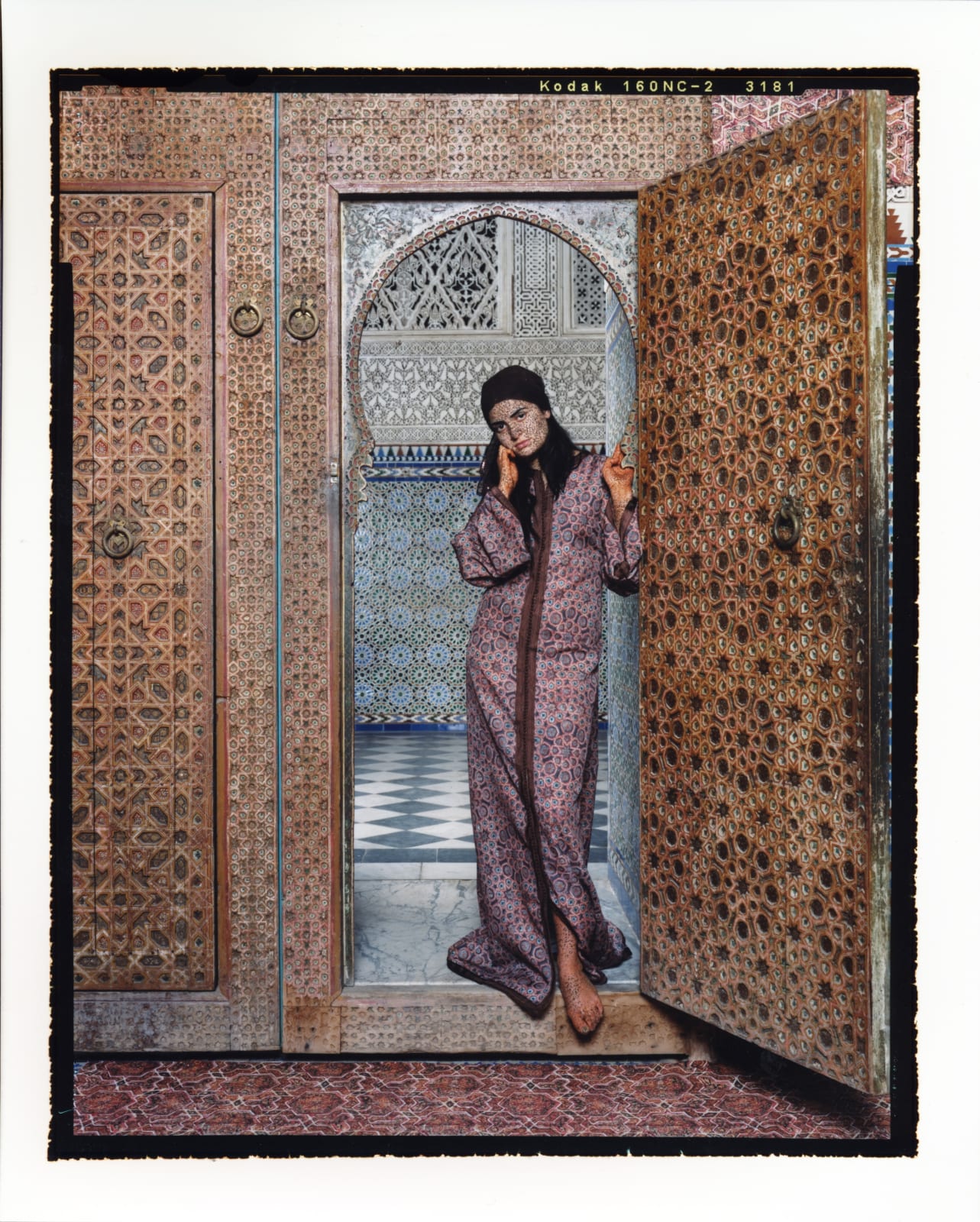 Woman standing in arched doorway of Moroccan palace, from Harem series by Lalla Essaydi