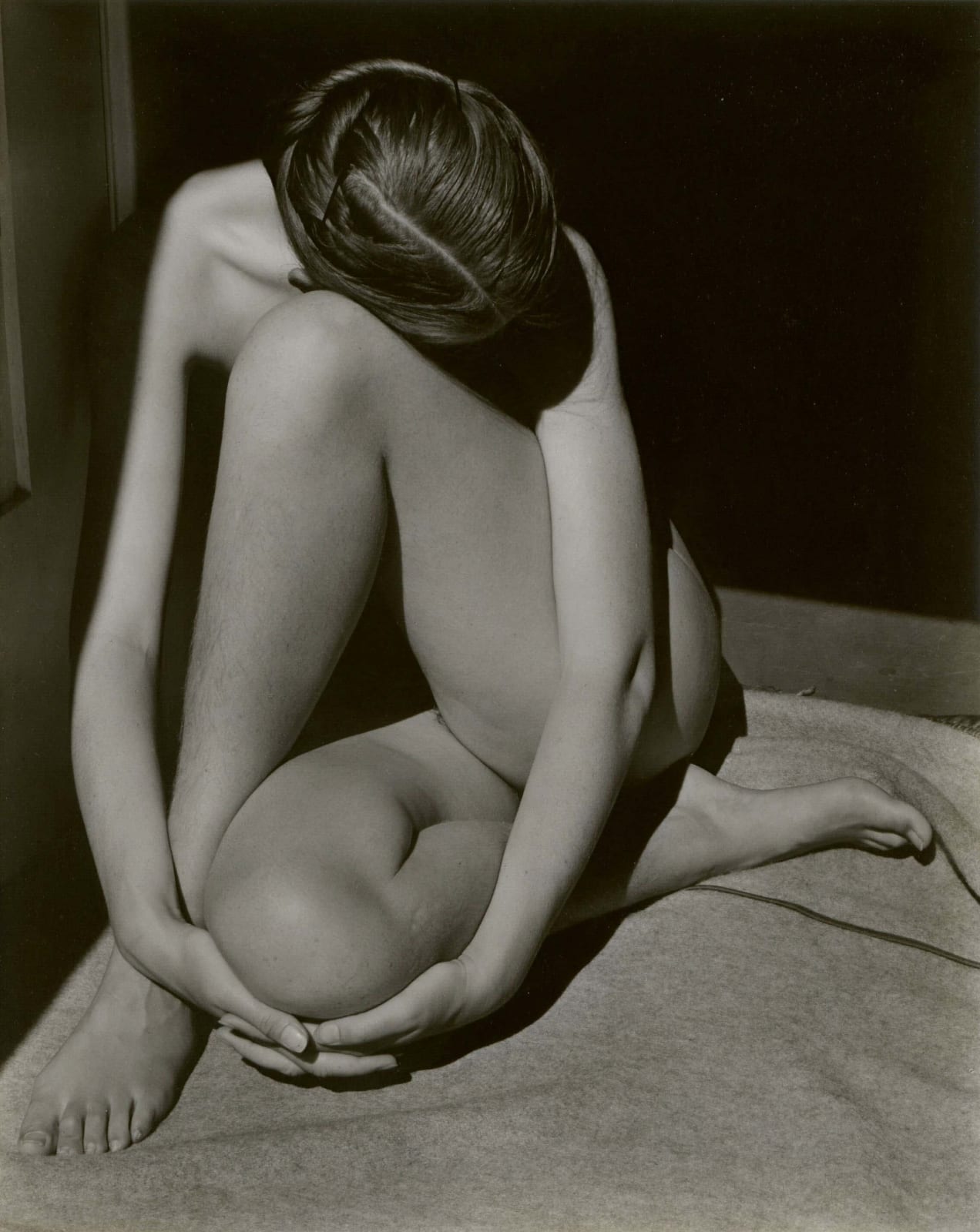 Edward Weston Nude Charis Weston nude study of woman in doorway with hands tucked under knee and head down