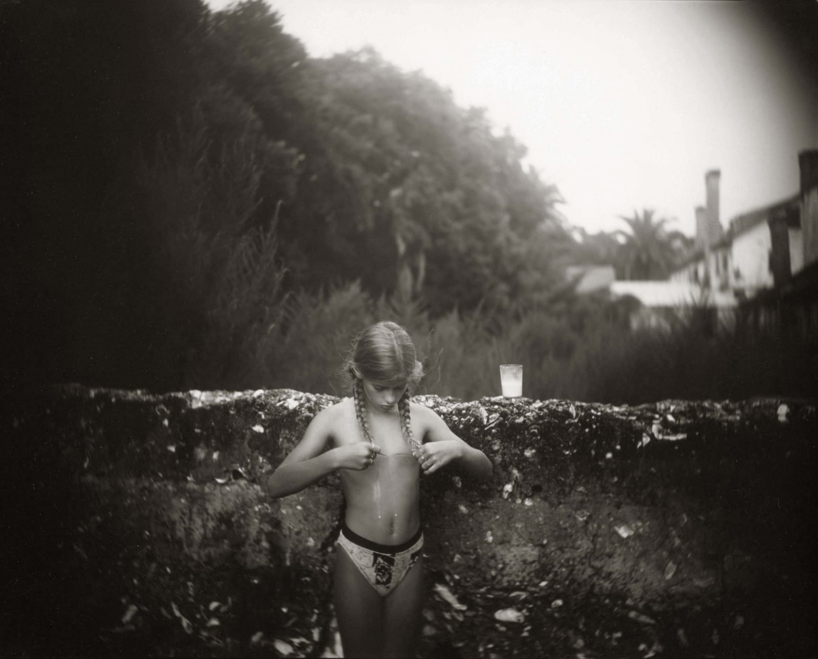 Jessie with glass of milk, from the Immediate Family series, by Sally Mann