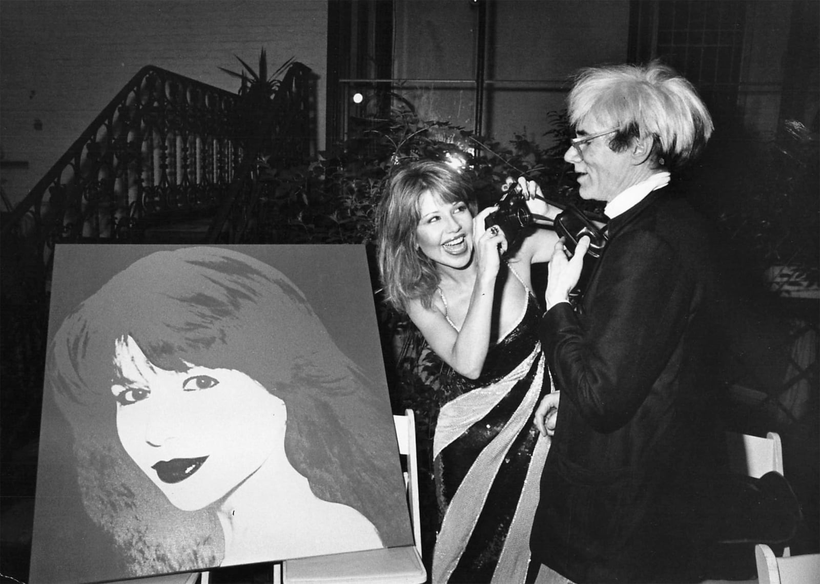Ron Galella, Andy Warhol and Pia Zadora at a party at the home of "Penthouse" owner Bob Guccione, September 6, 1983