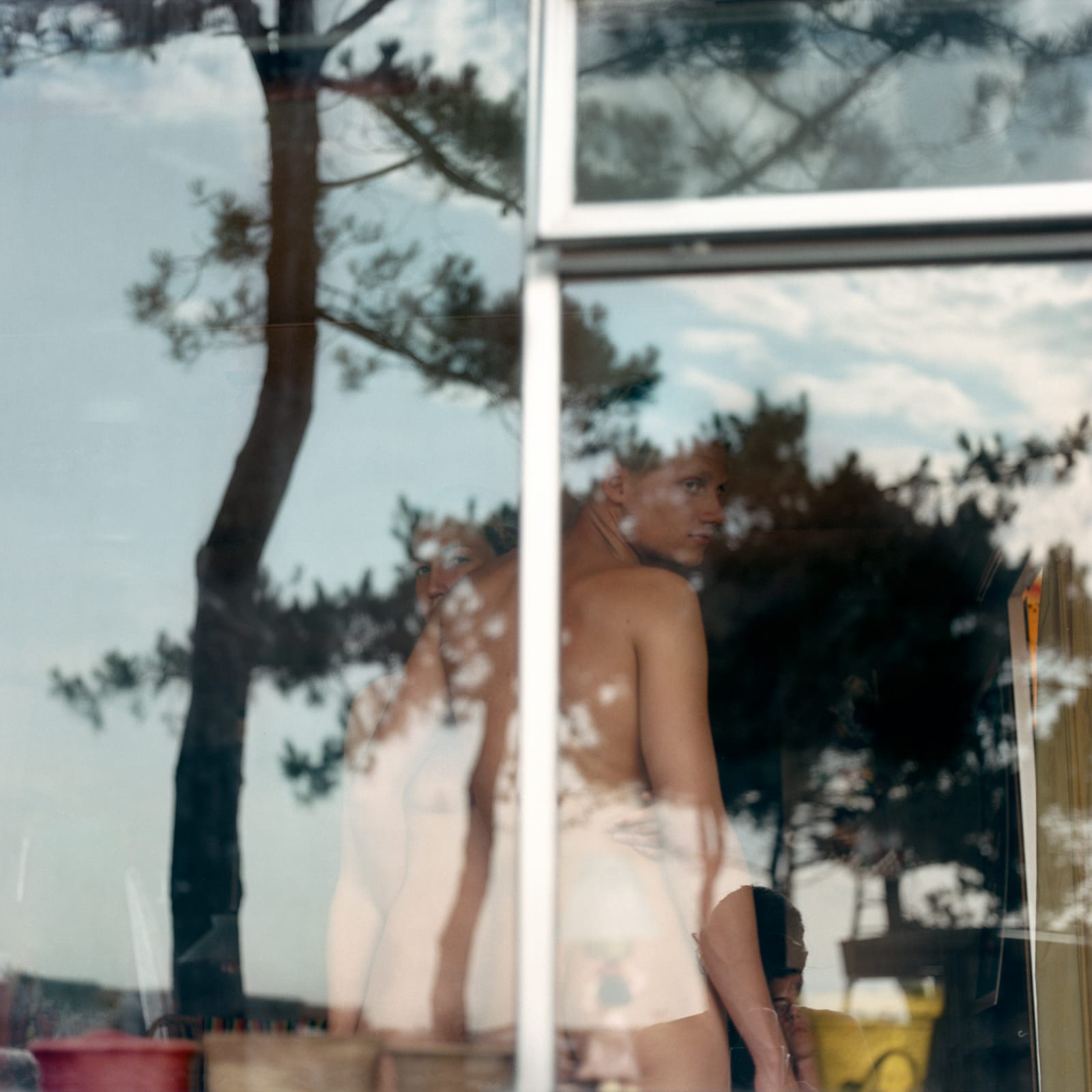 Mona Kuhn, Closer, Amsterdam I (reflection of body and tress on glass), 2004