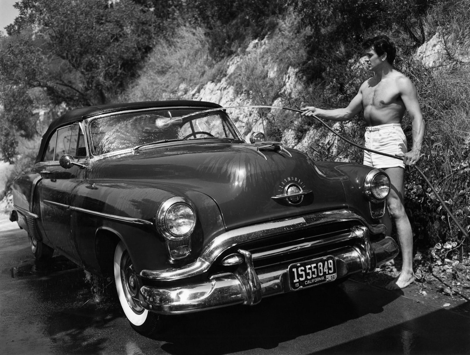 Sid Avery, Rock Hudson Washing His Car Outside His Hollywood Home, 1952