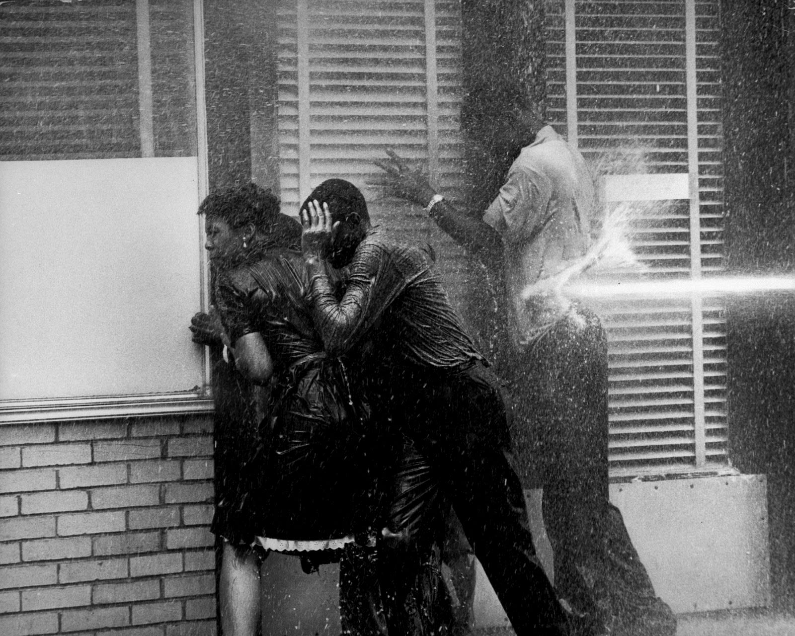 Charles Moore, Three People in Doorway Being Fire Hosed, Birmingham, AL, 1963