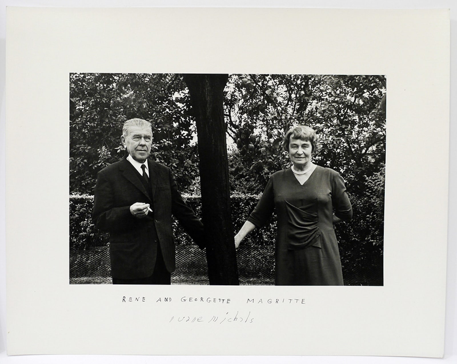 Duane Michals, Rene & George Magritte Holding Hands Behind a Tree, 1965