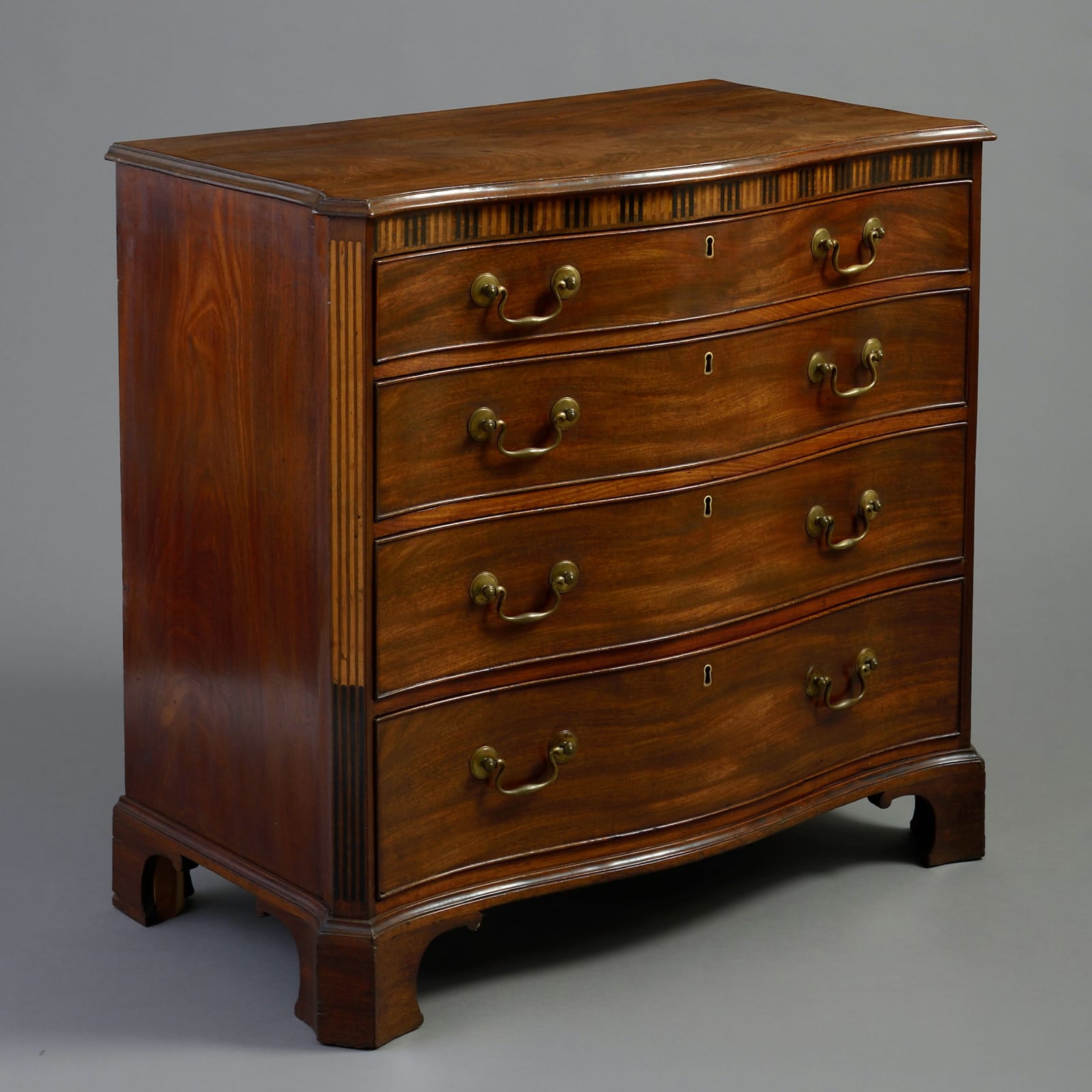 GEORGE III MAHOGANY SERPENTINE COMMODE