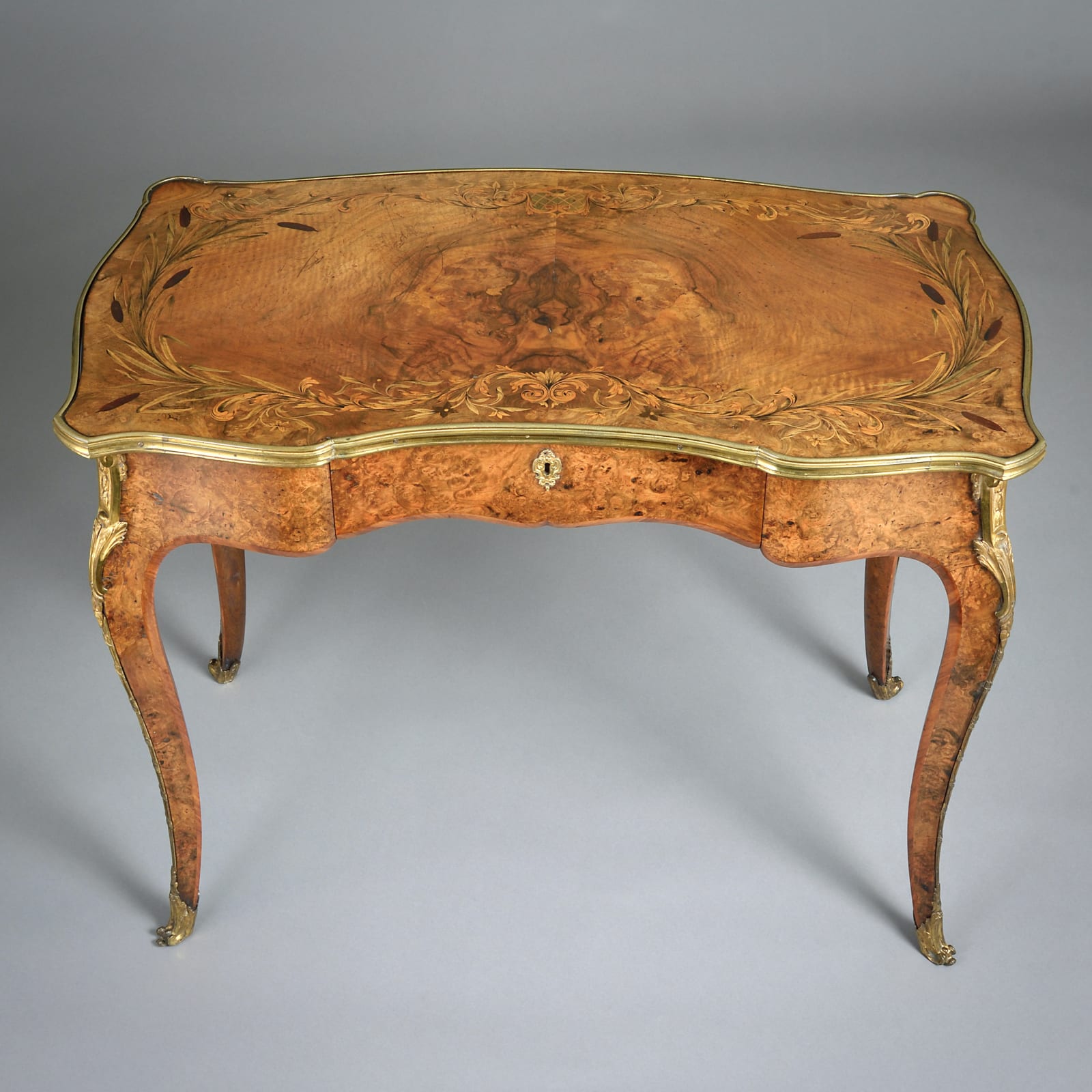 EARLY VICTORIAN ORMOLU-MOUNTED BURR-WALNUT MARQUETRY WRITING TABLE