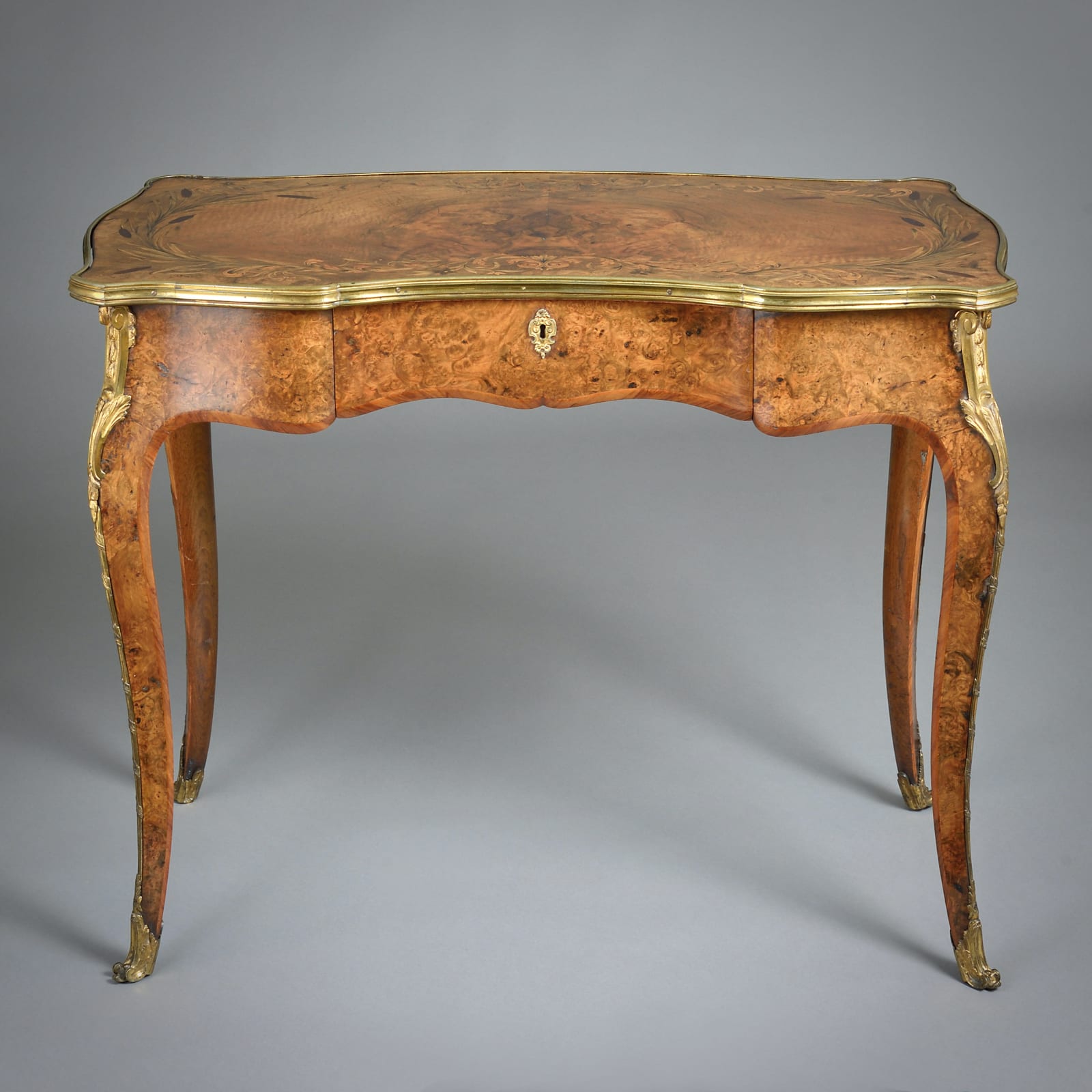 EARLY VICTORIAN ORMOLU-MOUNTED BURR-WALNUT AND MARQUETRY WRITING-TABLE