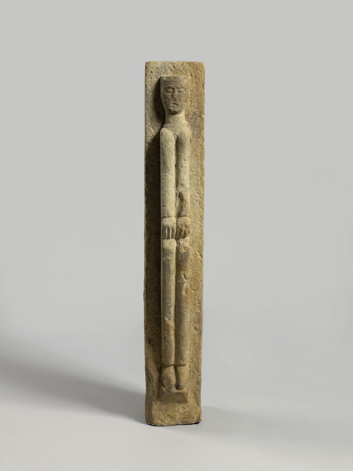 A full-length figure of a man with his hands on his knees, 11th Century Burgundy