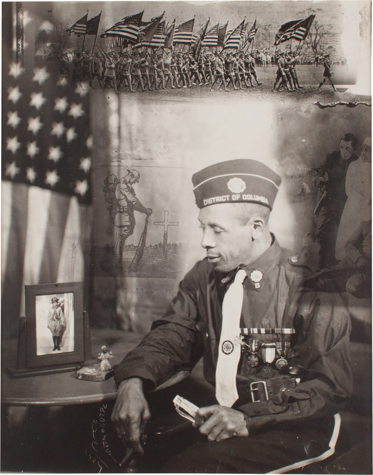 James Van Der Zee, Untitled [Seated Man in Military Costume, with Framed Photograph and American Flag], 1934
