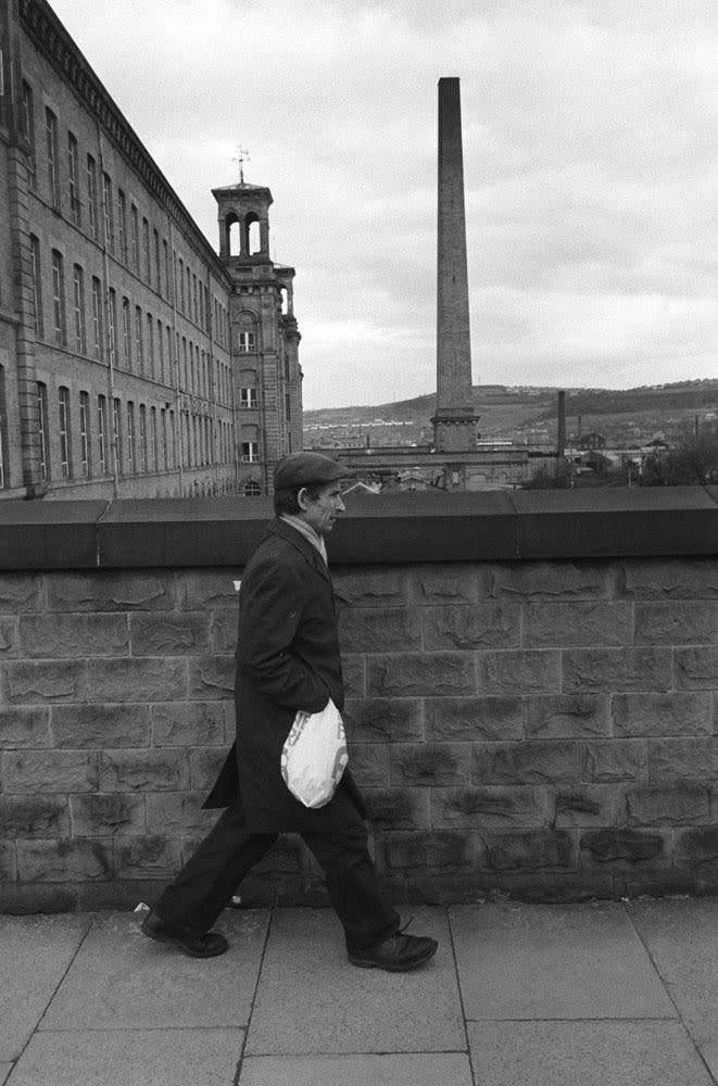 Homer Sykes, Factory worker going home, Salts Cotton Mill, Saltaire, Yorkshire, 1981