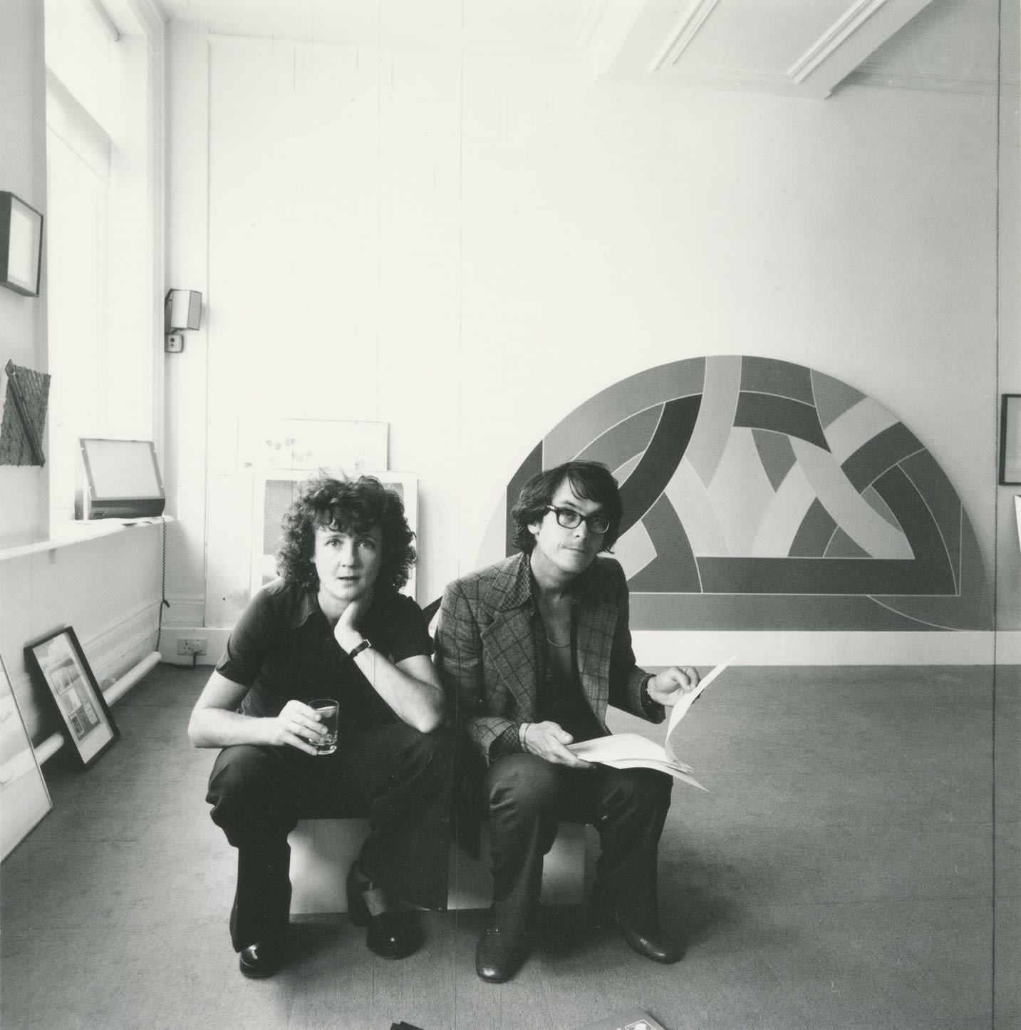 Kasmin, Lindy and Sheridan Dufferin in the Kasmin Gallery; behind them a Frank Stella painting, Clifford Street, London, c. 1975