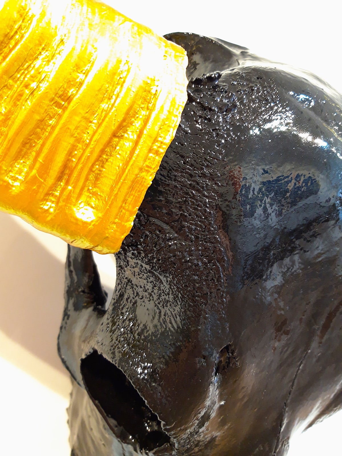 ANGELA MORRIS-WINMILL, BLACK RESIN SKULL WITH GOLD RESIN HORNS