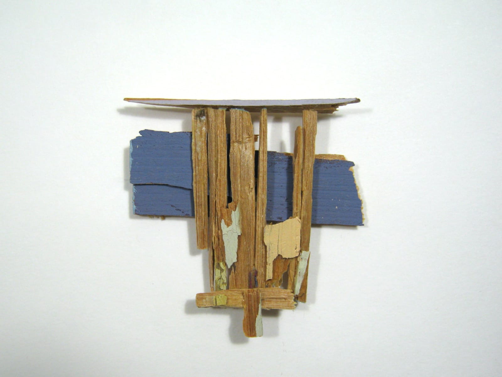 abstract wooden wall sculpture with blue paint