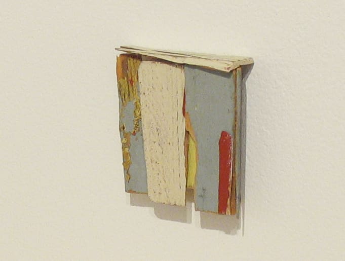 abstract wooden wall sculpture with gray red and yellow paint