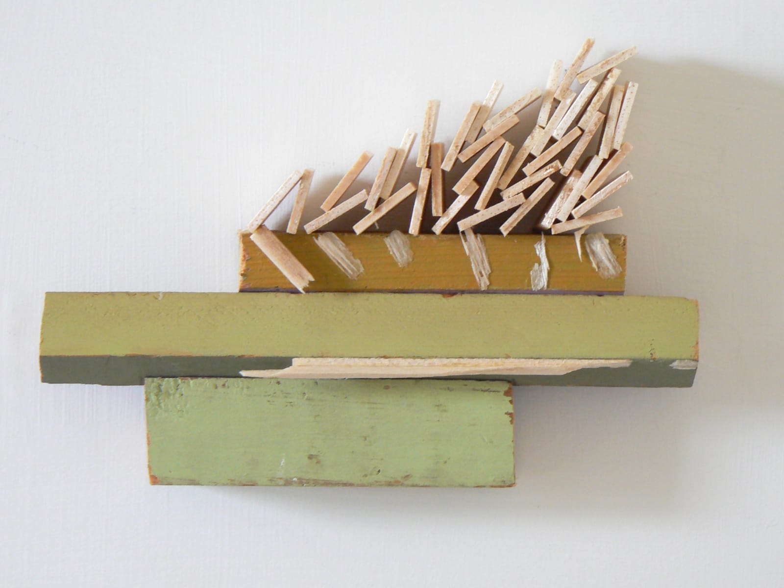 abstract wooden wall sculpture with green paint