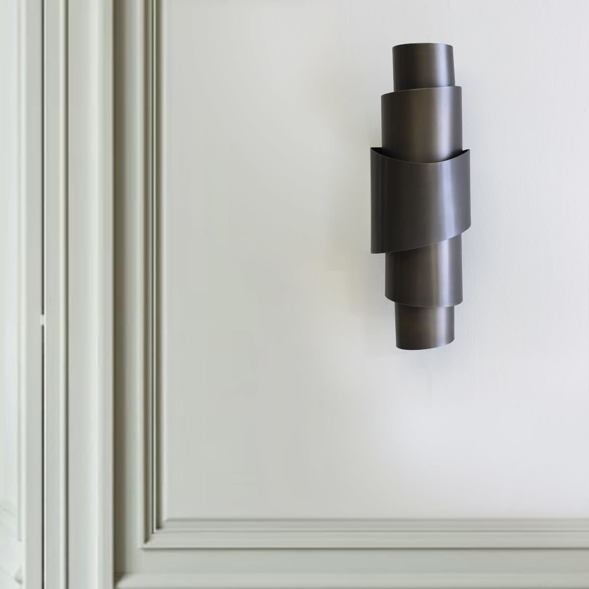 Contour sconce on panelled wall