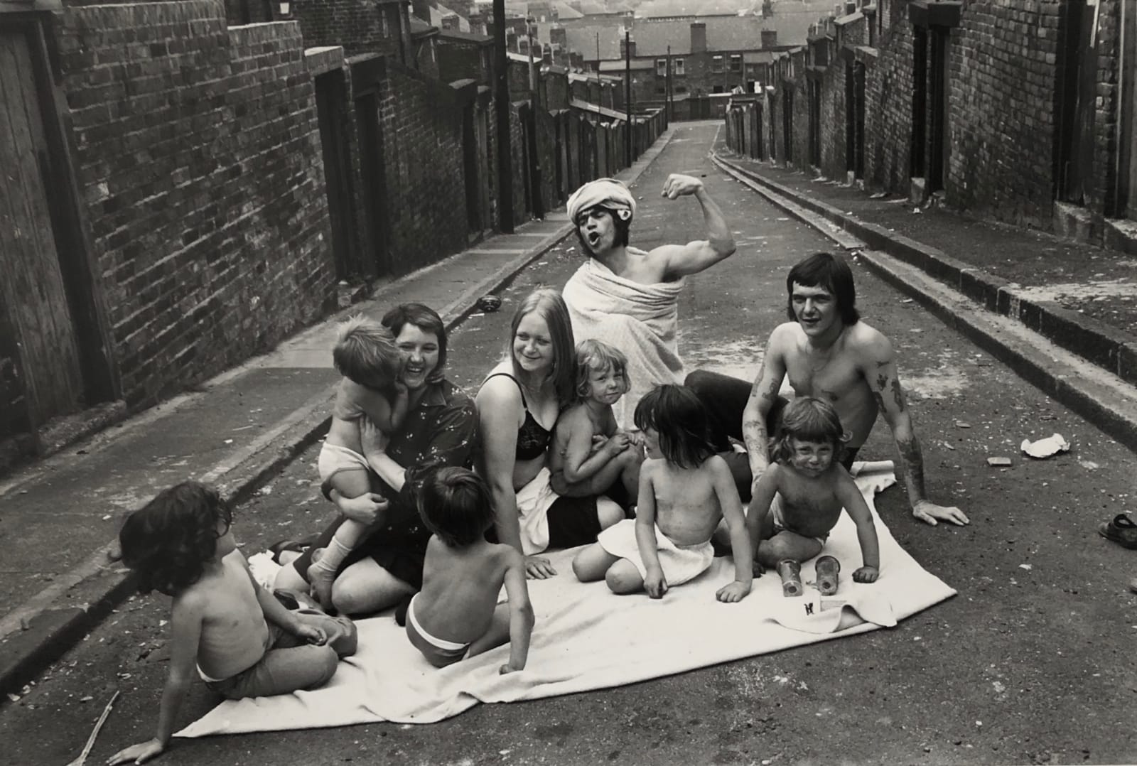 Sirkka-Liisa Konttinen, Two Families Sunbathing in Carville Road/Mason Street Backlane, Byker, 1975