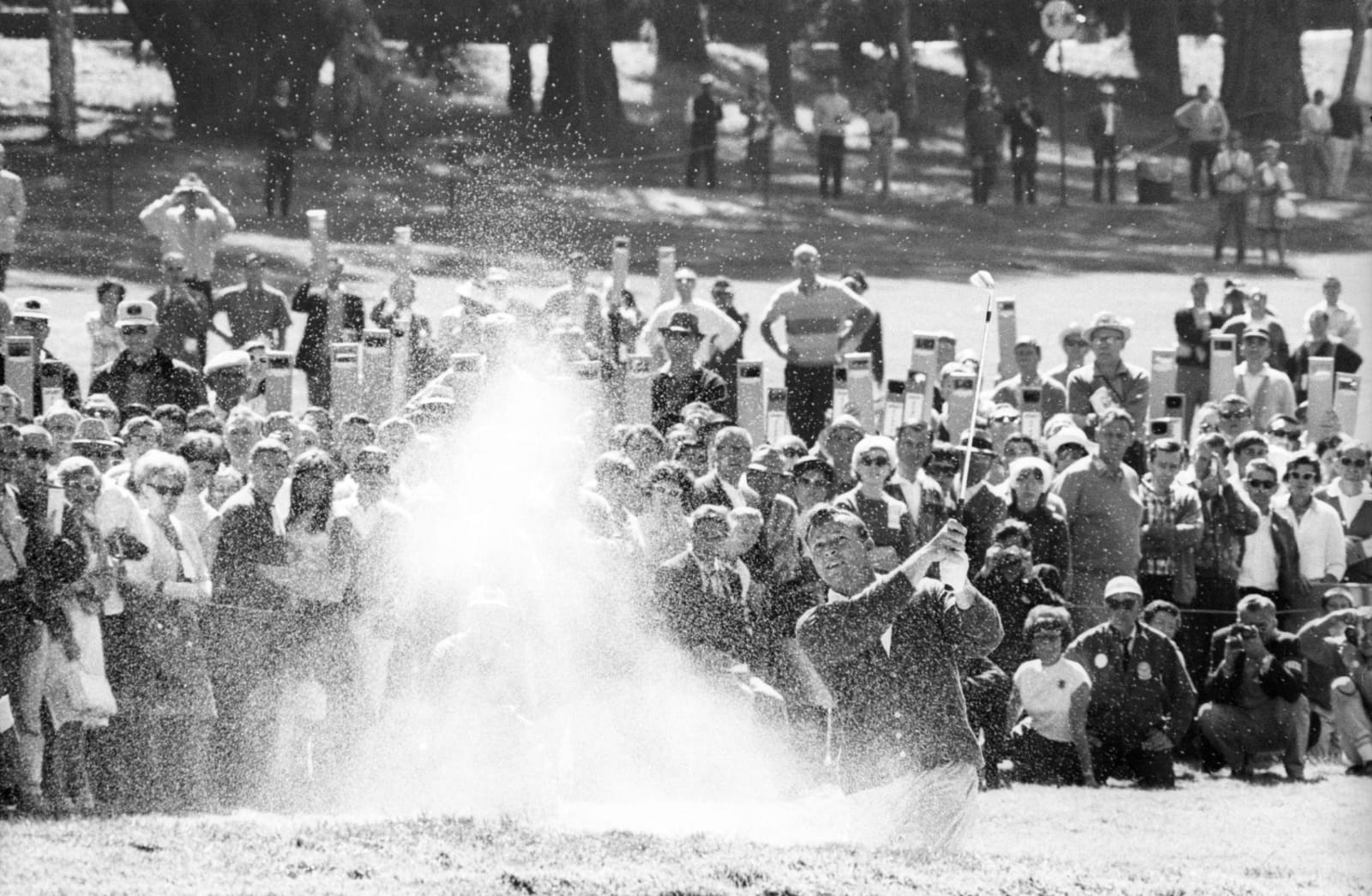 Neil Leifer, Arnold Palmer kicks up sand after hitting out of the bunker during Round 4 of the 1966 US Open at the Lake Course of The Olympic Club. San Francisco, California, 1966