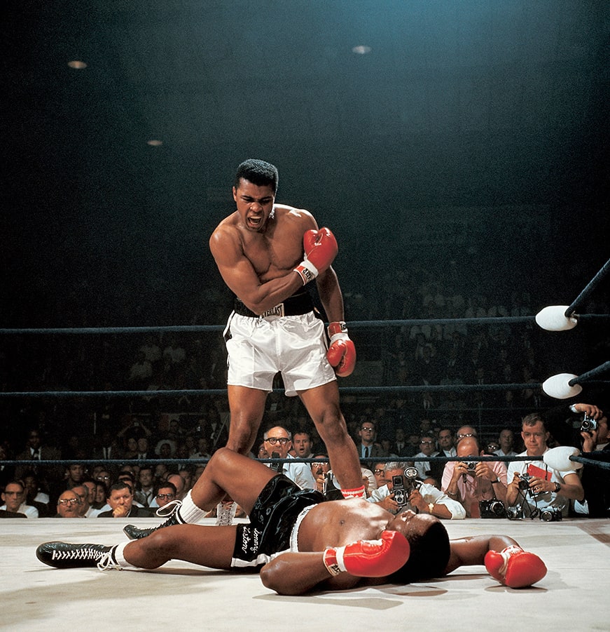 Neil Leifer, Muhammad Ali reacts after his first round knockout of Sonny Liston during the 1965 World Heavyweight Title fight at St. Dominic's Arena. Lewiston, Maine, 1965