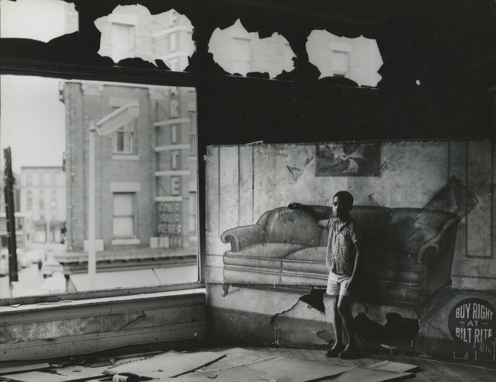 Arthur Tress, Boy in Burnt Out Furniture Store, Newark, NY, 1969