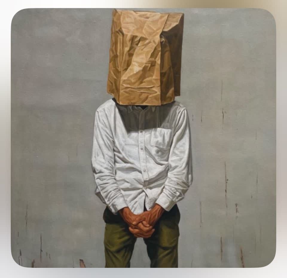 Man with brown paper bag over his head 