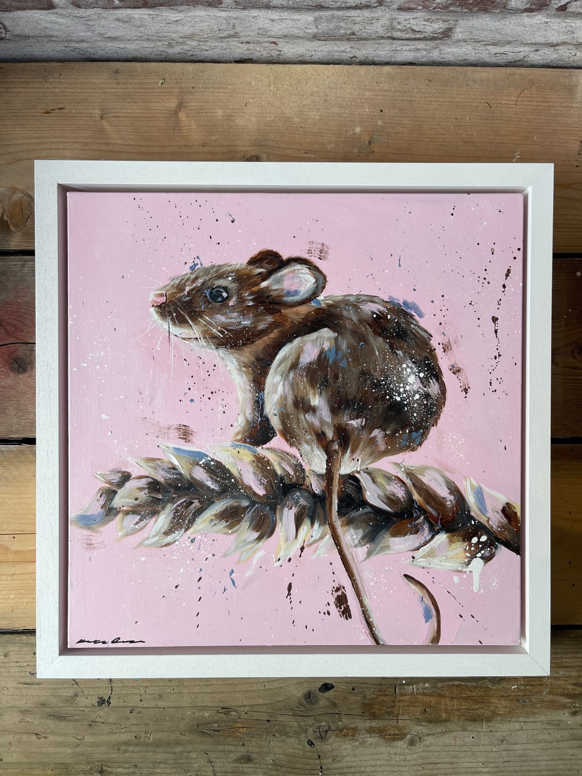 mouse sat on stem with pink background