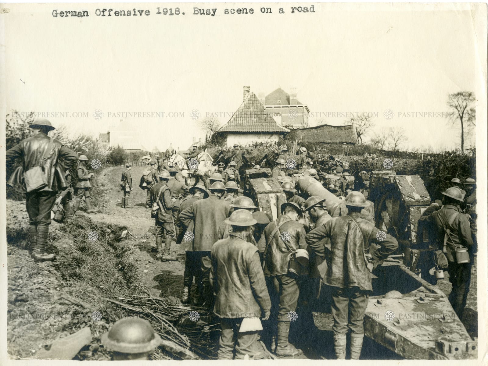 The Associated Illustration Agency, LTD. London, German Offensive 1918. Busy scene on a road. British troops pushing huge canon to front lines. Western Front France. , 1918