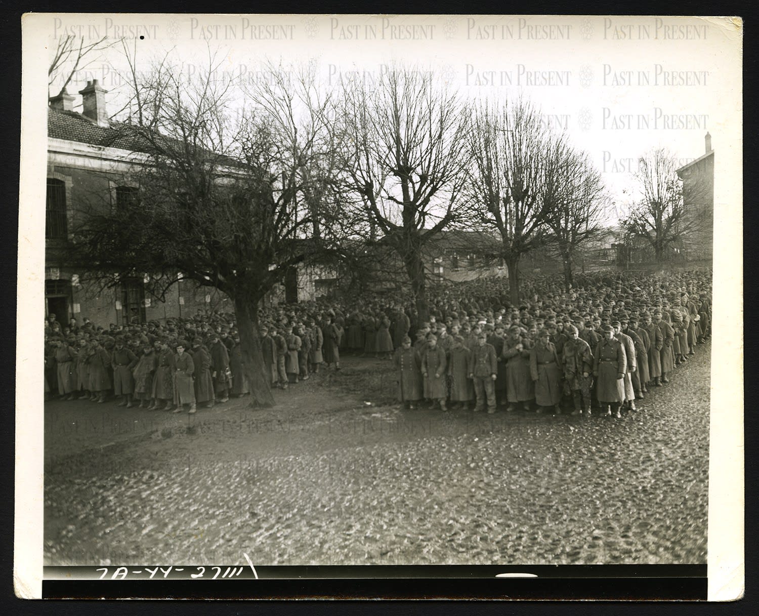 Roland Meade, German prisoners who were captured in Strasbourg being segregated at Epinal stockage into smaller groups for further shipment to rear areas France 11.27.44, 1944