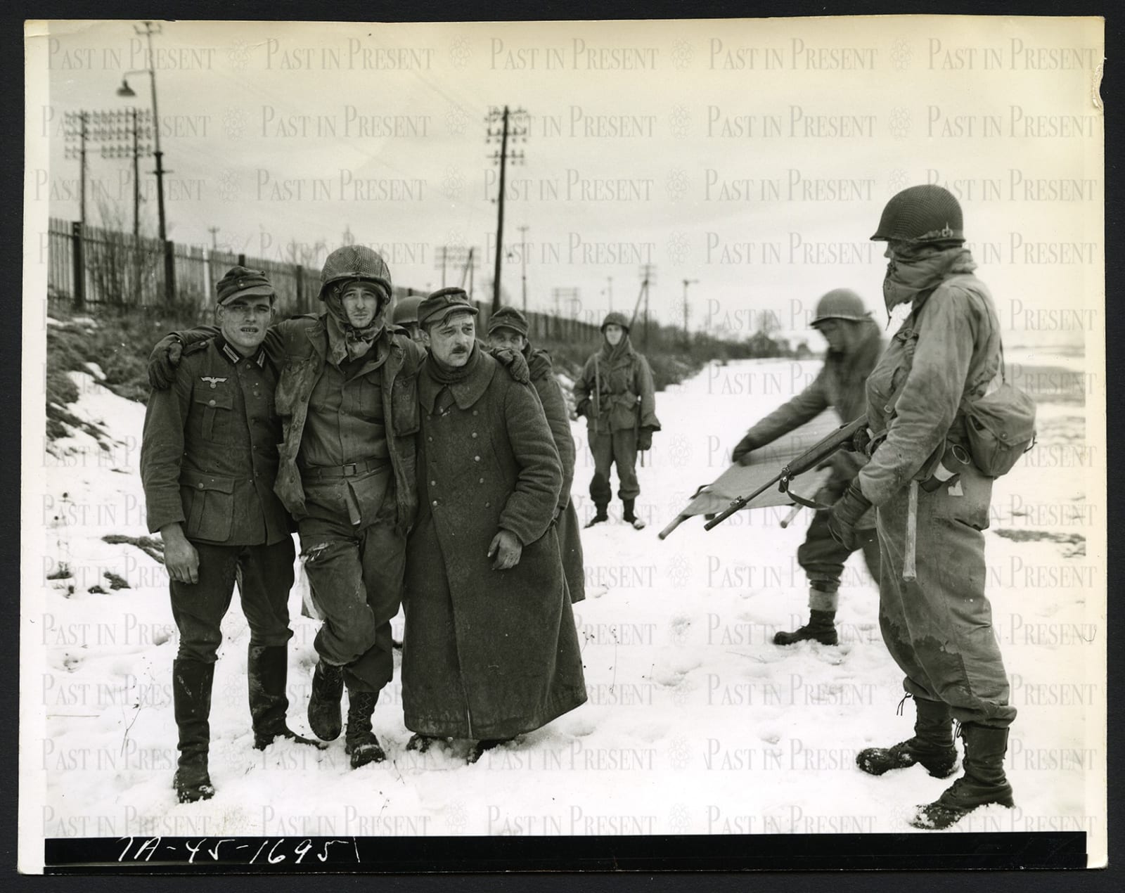Wehrmacht POW's help wounded US Soldier, Colmar France, 1945