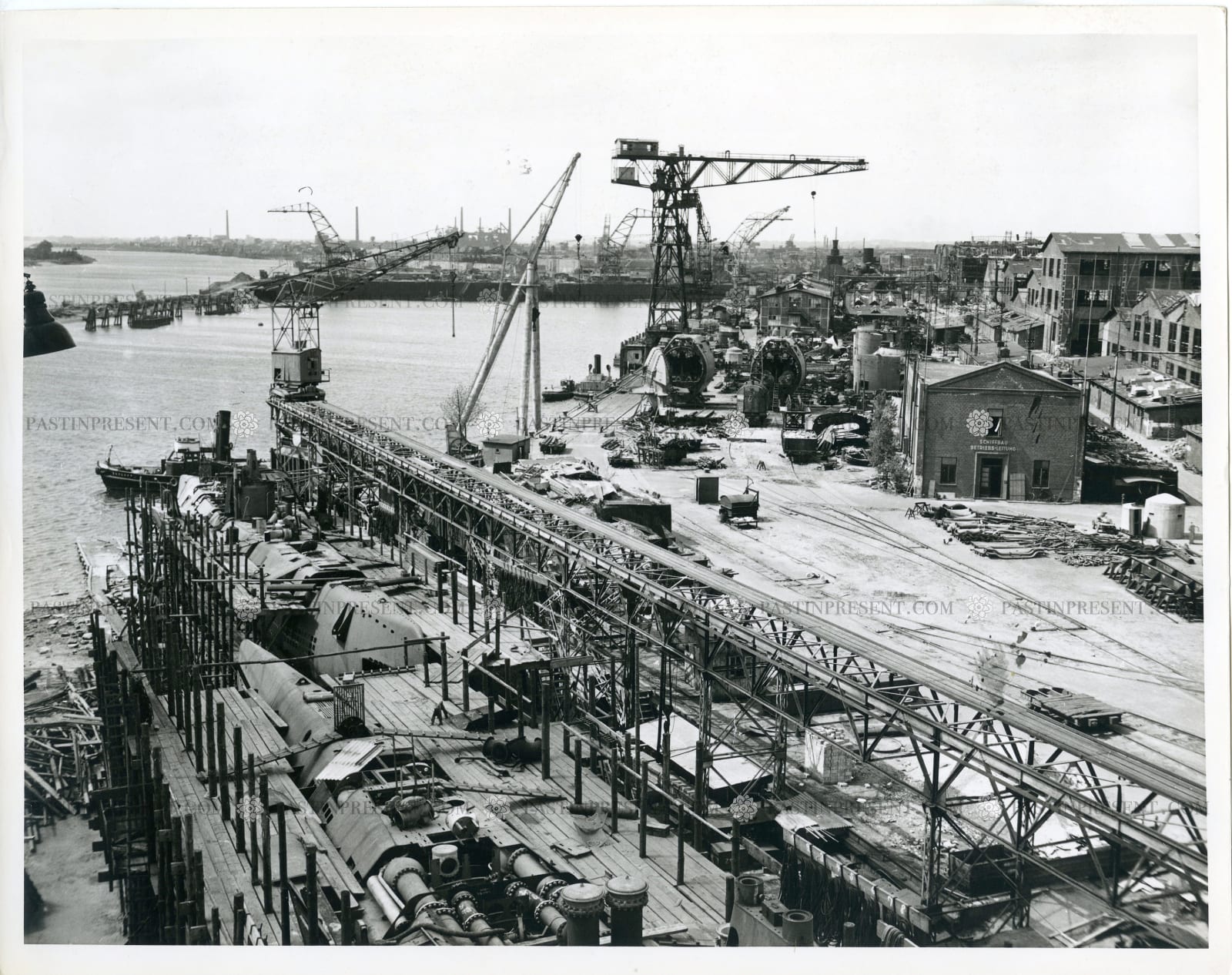 M.A. Nicholson, Captured German U-Boat Base in Werftanlagend A.G. Weser, Bremen, Germany. You can see a couple of submarines in the lower left 5.14.45 , 1945
