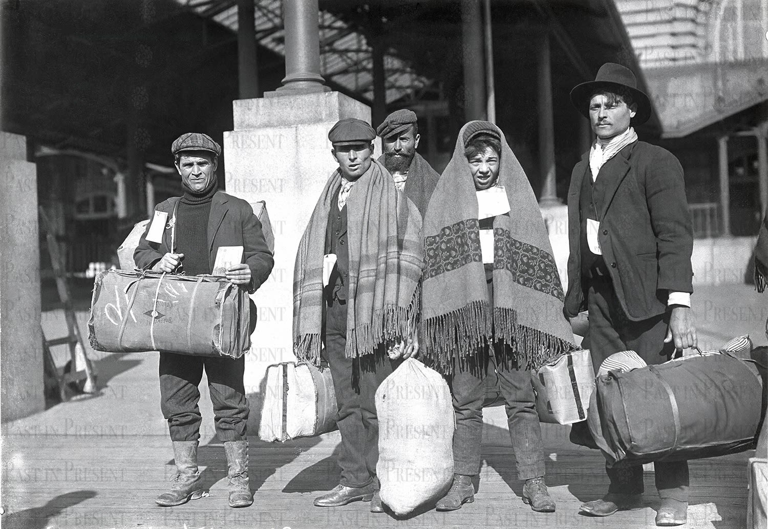 “Carrying the Weight of Hope: Immigrants at the Threshold of a New Life, Ellis Island, c.1900s”, c.1900s