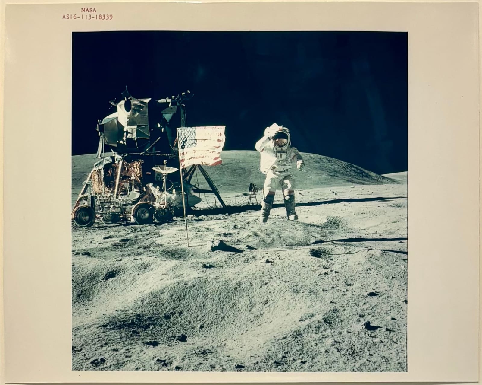 NASA, Astronaut John W. Young, commander of the Apollo 16 lunar landing mission, leaps from the lunar surface as he salutes the United States flag at the Descartes landing site, April 1972