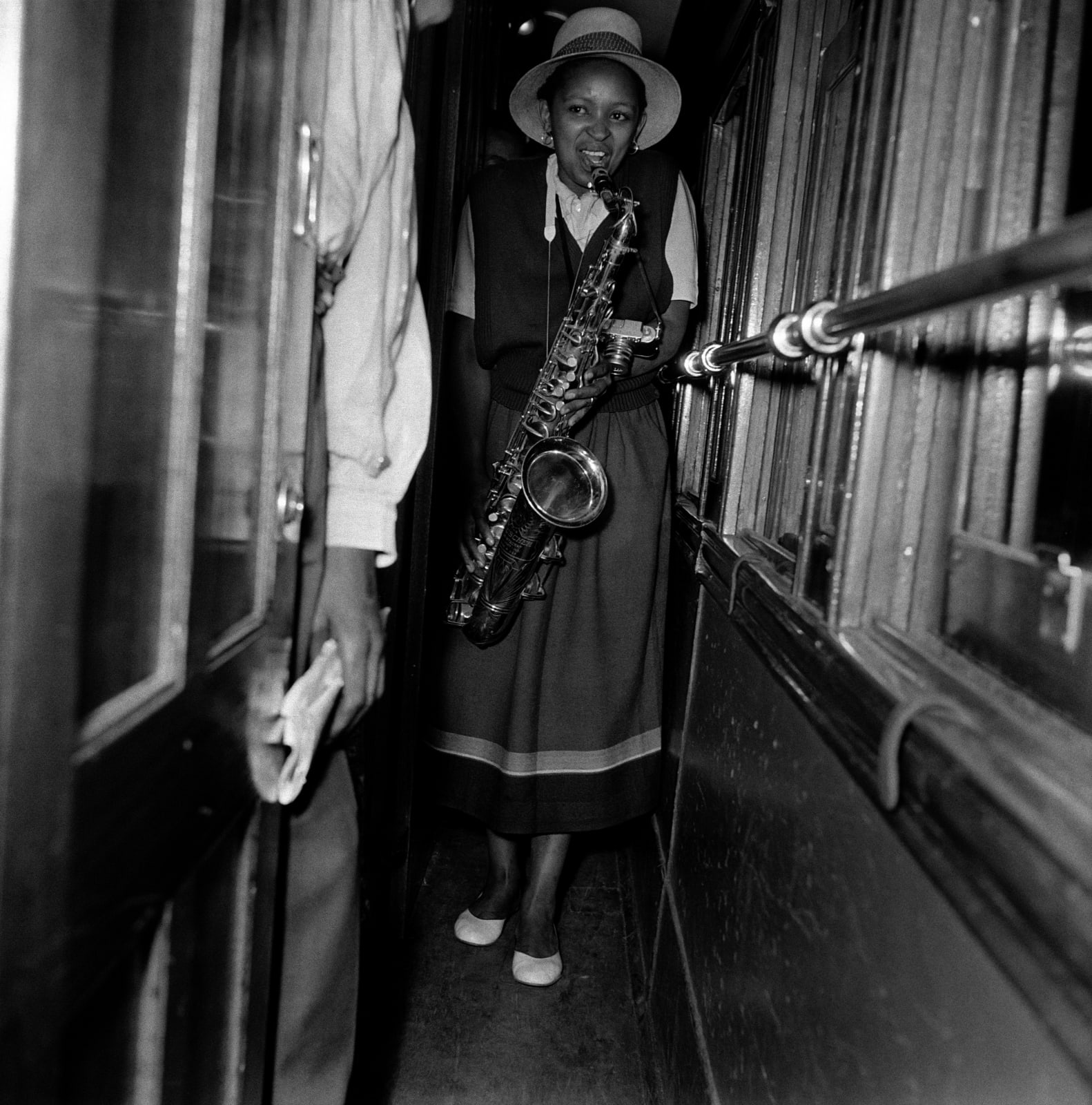Bob Gosani, Dolly Rathebe with saxophone on train to Durban, c.1955, printed 2025
