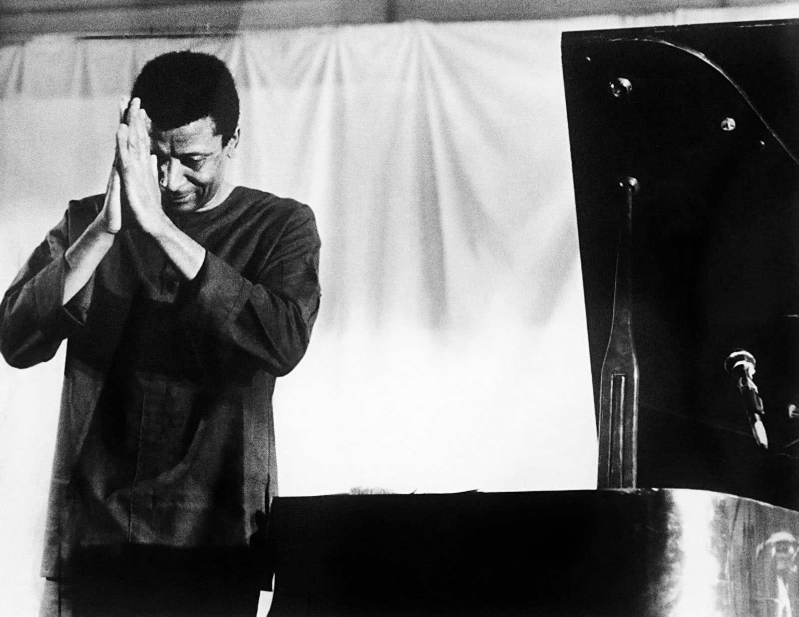 Alf Kumalo, Abdullah Ibrahim pays respects to the audience in a 1980s performance in Botswana, printed 2025