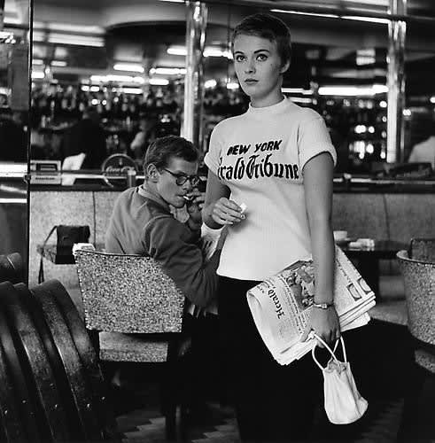 Raymond Cauchetier, Jean Seberg, Leaving a Café on the Champs Elysees to join the team shooting "À Bout De Souffle", 1959