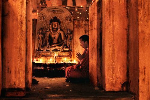 Steve McCurry, Monk Praying at Bodh Gaya, India, 2000