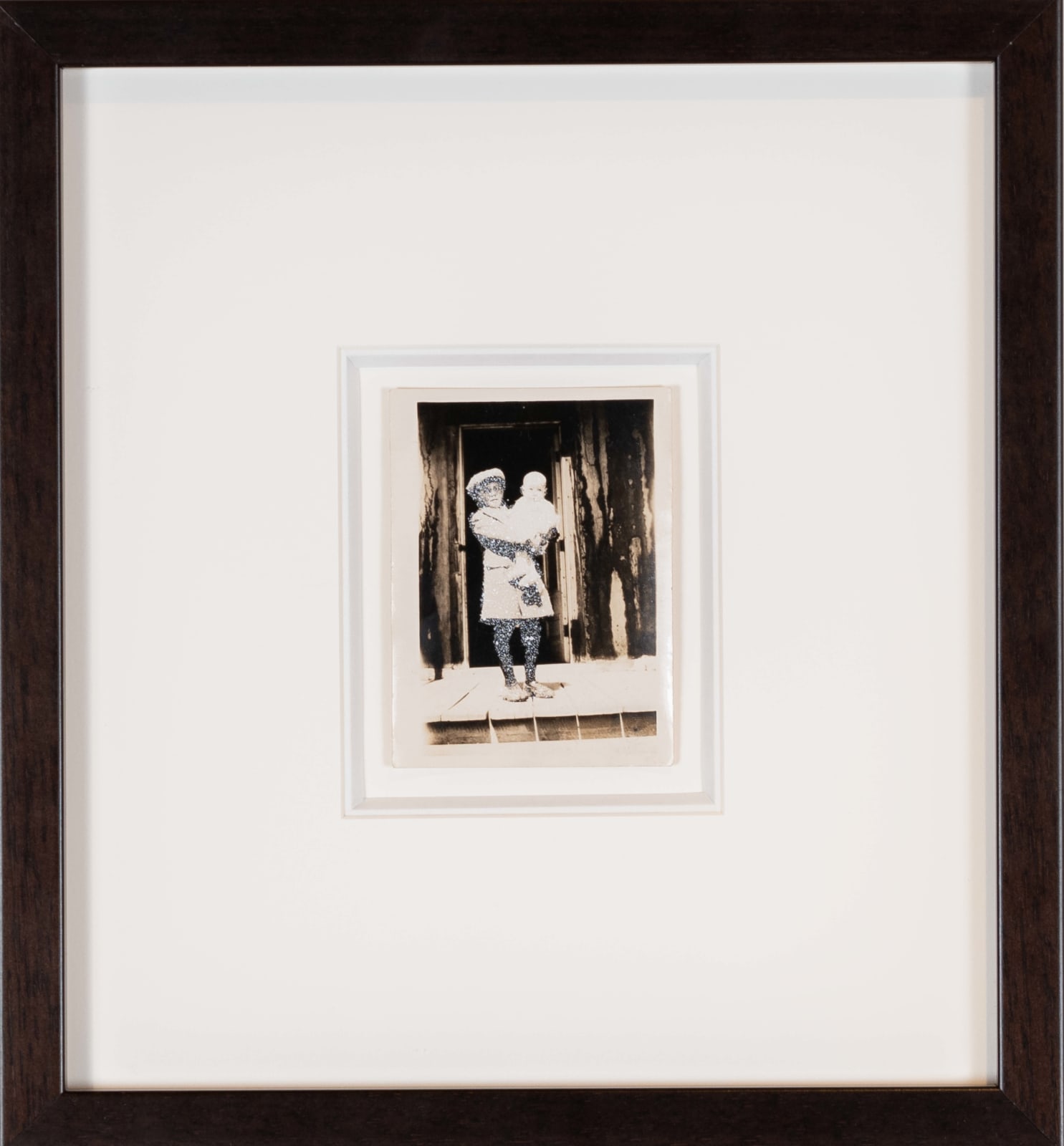 John Latour, Young boy in coat and cap holding a baby in his arms, 2015