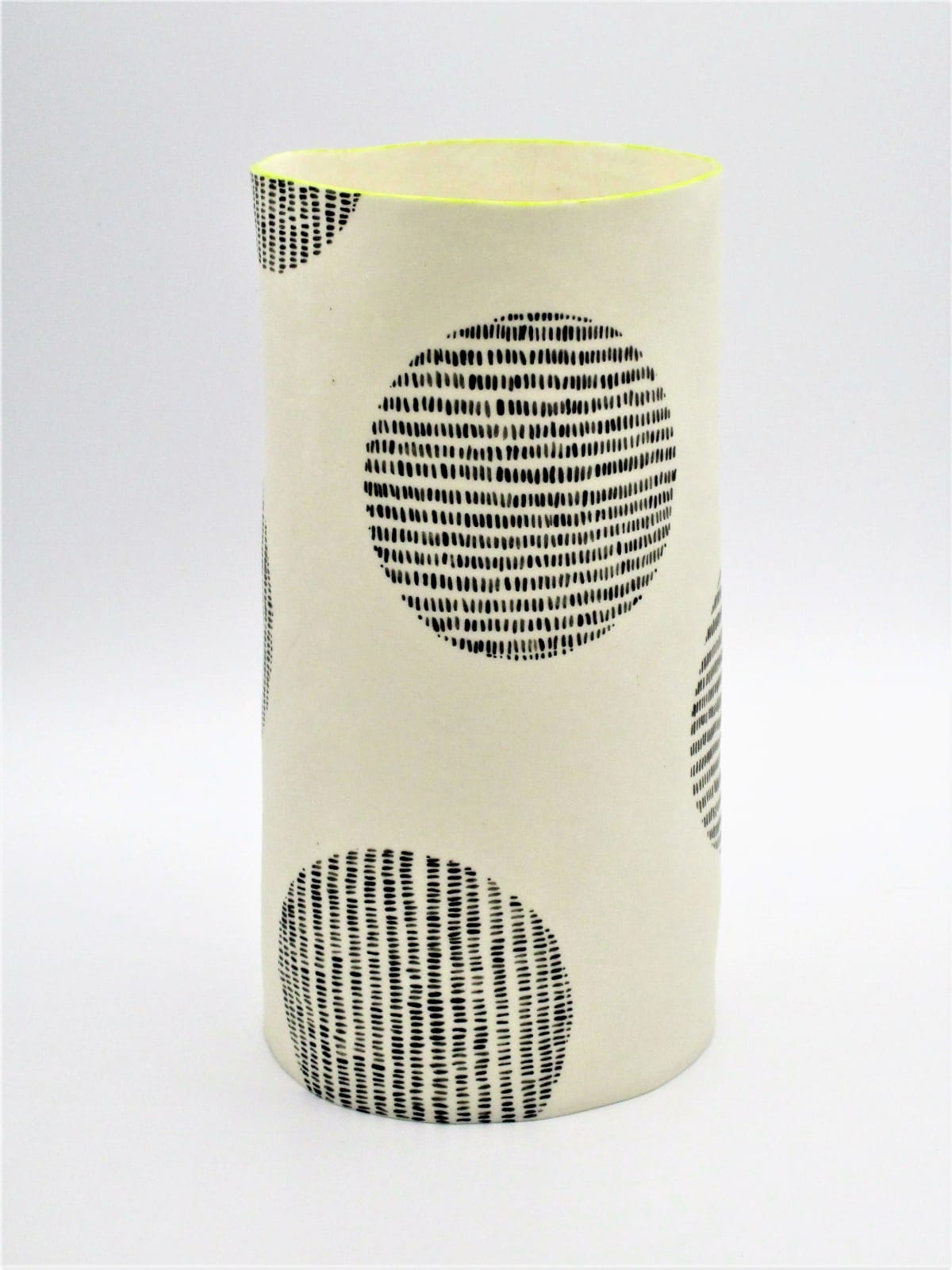 Jane Muende, Translucent white cylinder with black painted 'stitch lines' within circle, lime green rim, 2020