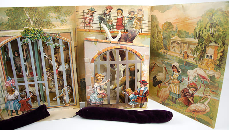 A Day in the Zoo. Realistic Pictures of Birds Beasts and Fishes. A Reproduction of an Antique Pop-up Book. Pop-up of big cats in cages. Interior pages with pop-ups of animals in cages.