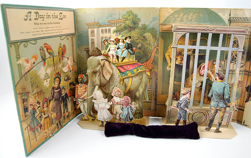 A Day in the Zoo. Realistic Pictures of Birds Beasts and Fishes. A Reproduction of an Antique Pop-up Book. Title page with pop-up of elephant and lions in a cage.
